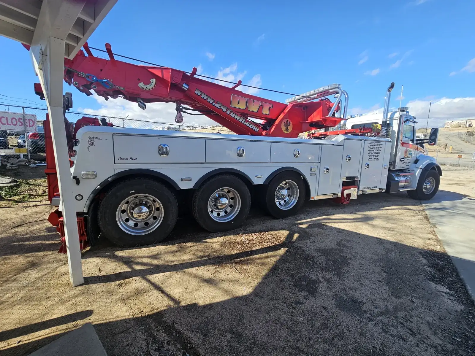 Desert Valley Towing heavy wrecker with a red DVT recovery boom and white truck cab