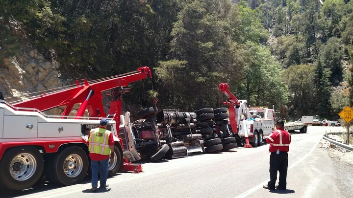 Desert Valley Towing crew recovering an overturned commercial truck